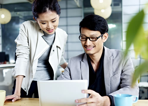 two people looking at laptop